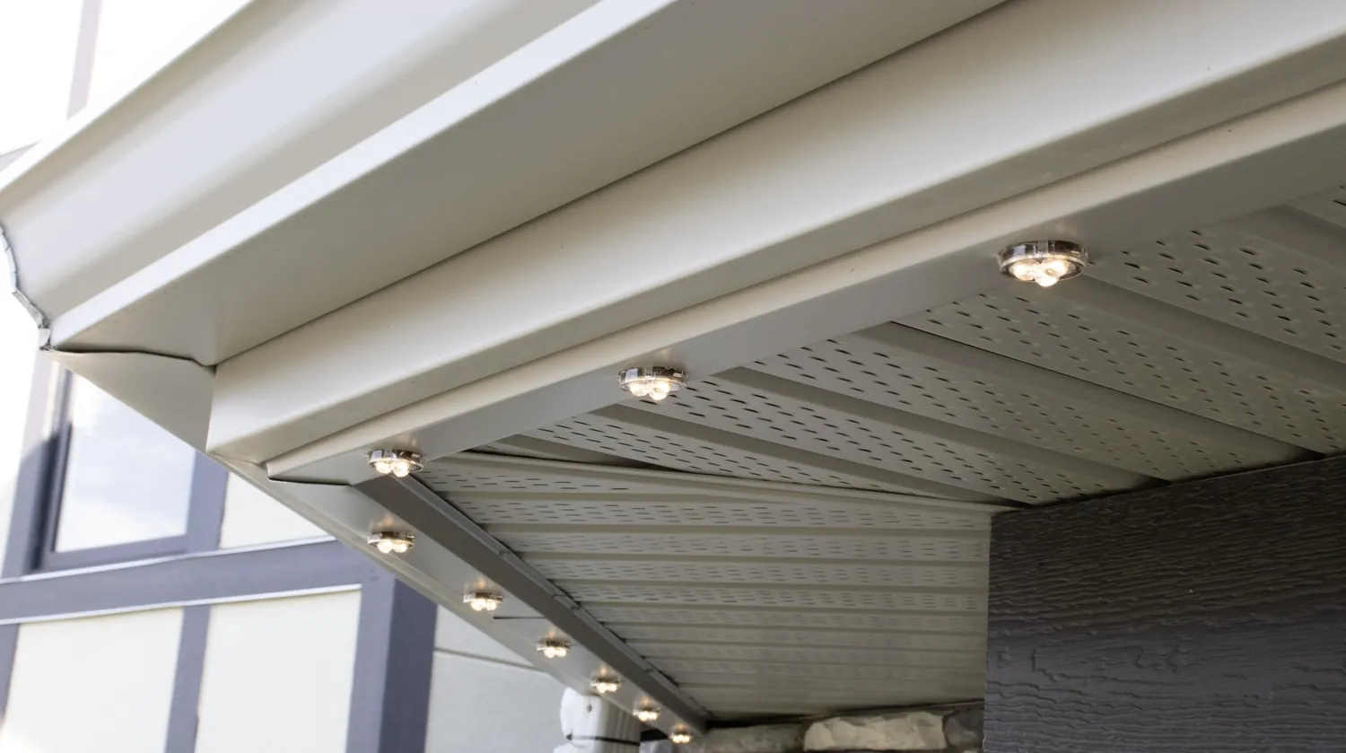 Row of discreet LED fixtures along the underside of the roofline